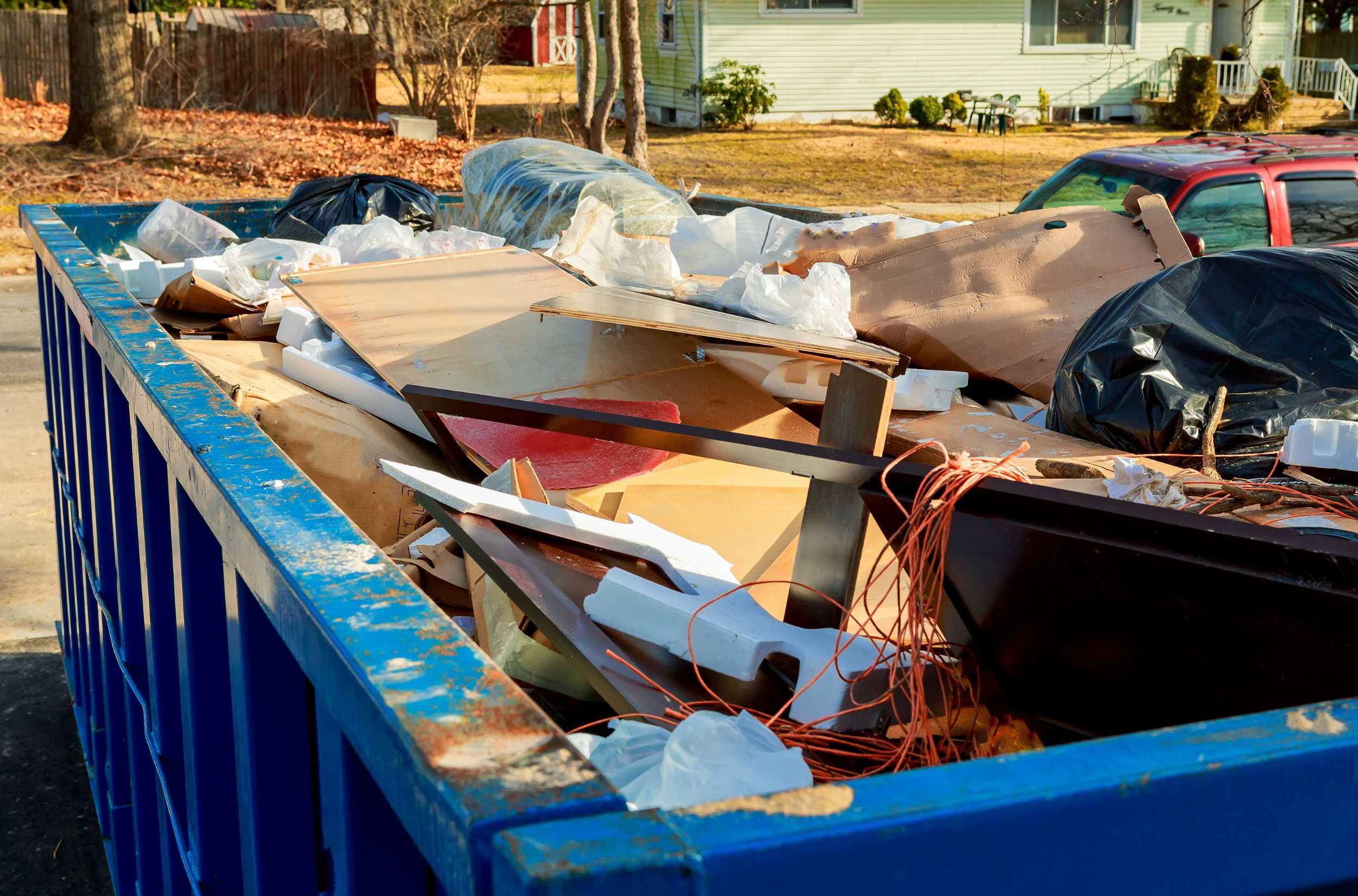 a blue dumpster full of garbage